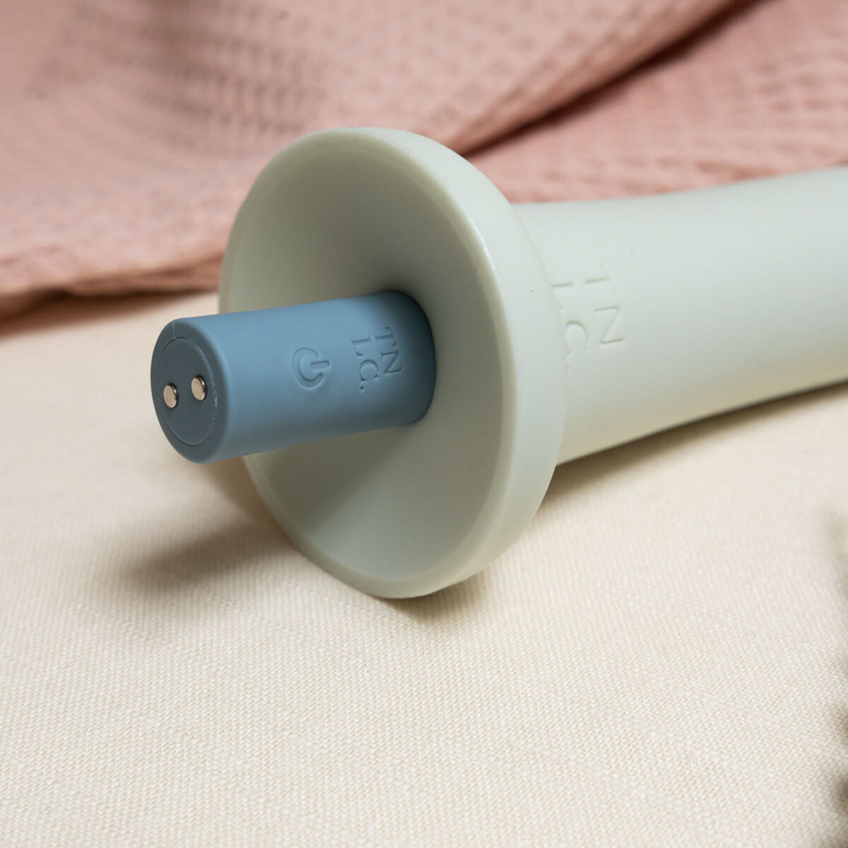 Close up showing Elemi bullet vibrator inserted into silicone dildo